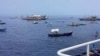 Perahu nelayan yang membawa aktivis dan relawan yang tergabung dalam koalisi non-pemerintah bernama Atin Ito melewati perairan Palauig Point, Zambales, barat laut Filipina saat menuju Scarborough Shoal pada 15 Mei 2024. (Foto: via AP)